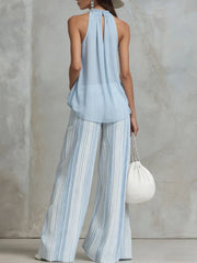 Stylish outfit featuring a sleeveless top and wide-leg striped pants