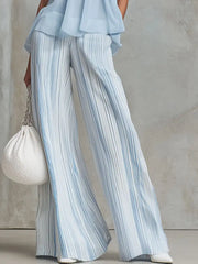 Stylish outfit featuring a sleeveless top and wide-leg striped pants